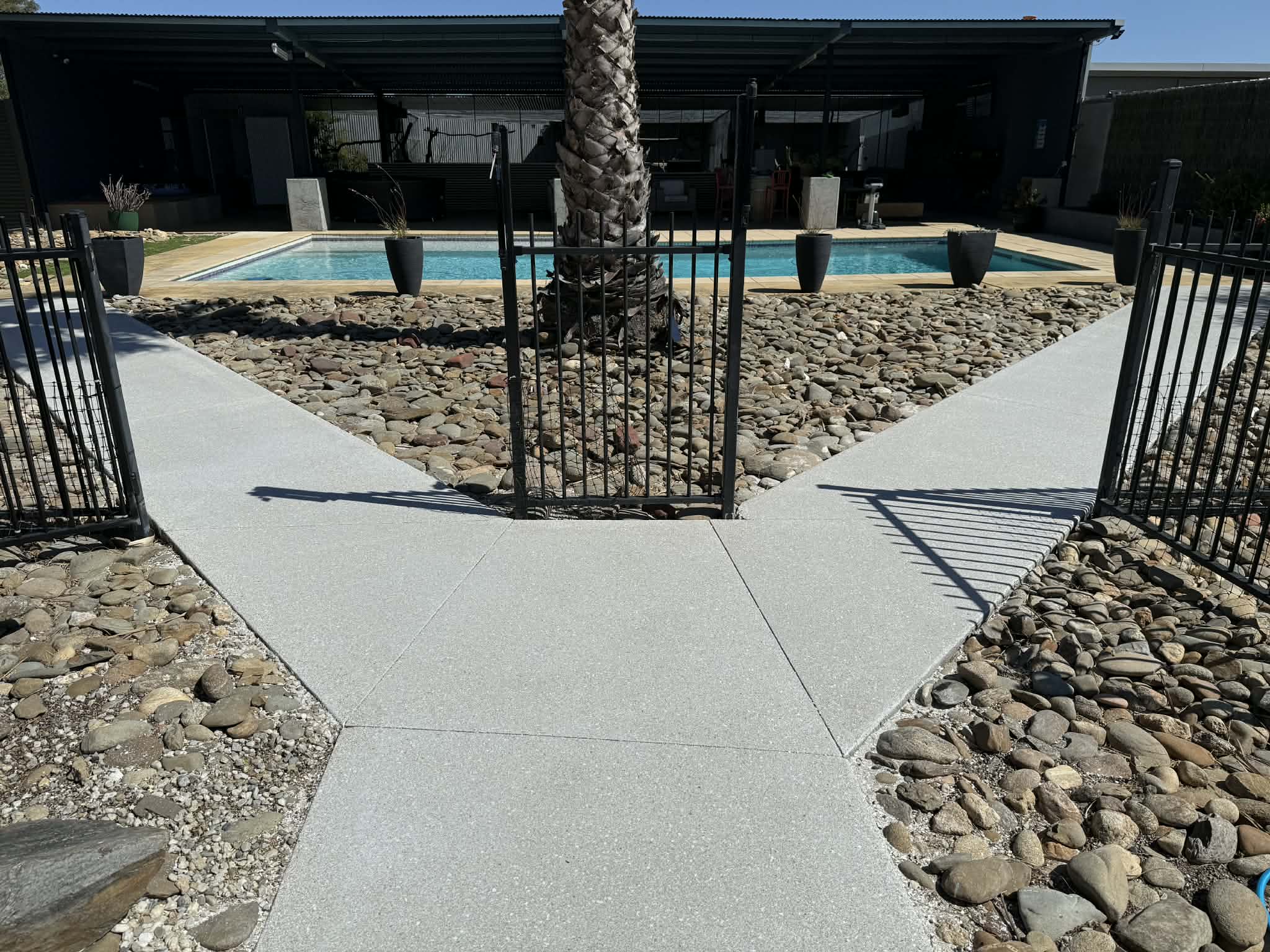 Honed concrete pool surround pathway